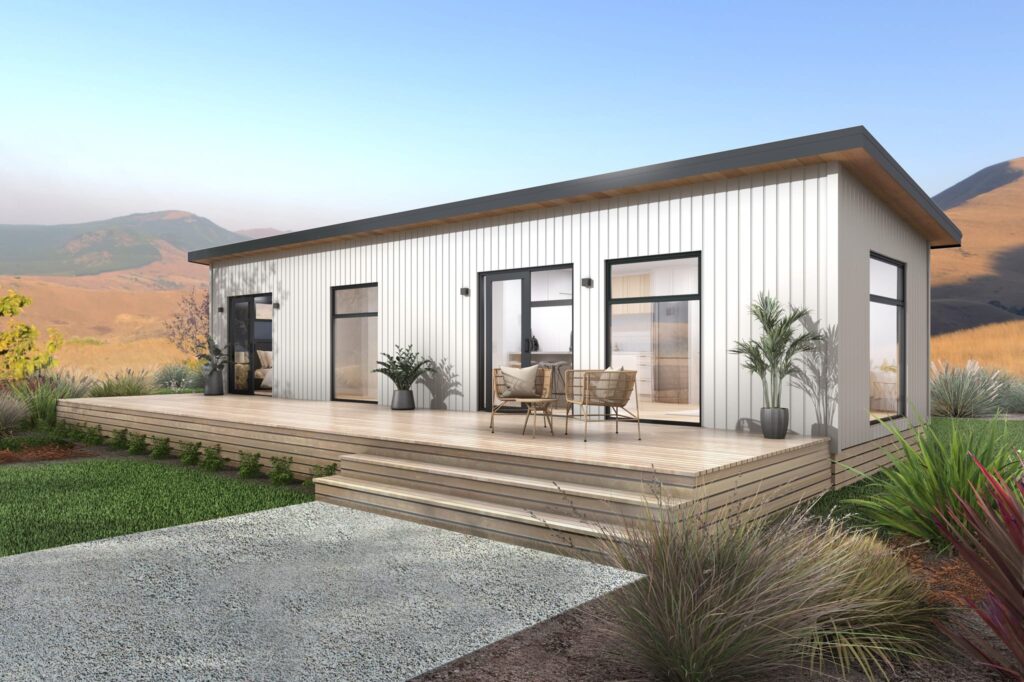 One bedroom portable home NZ with white vertical cladding and timber deck by Paragon Portables, relocatable homes.