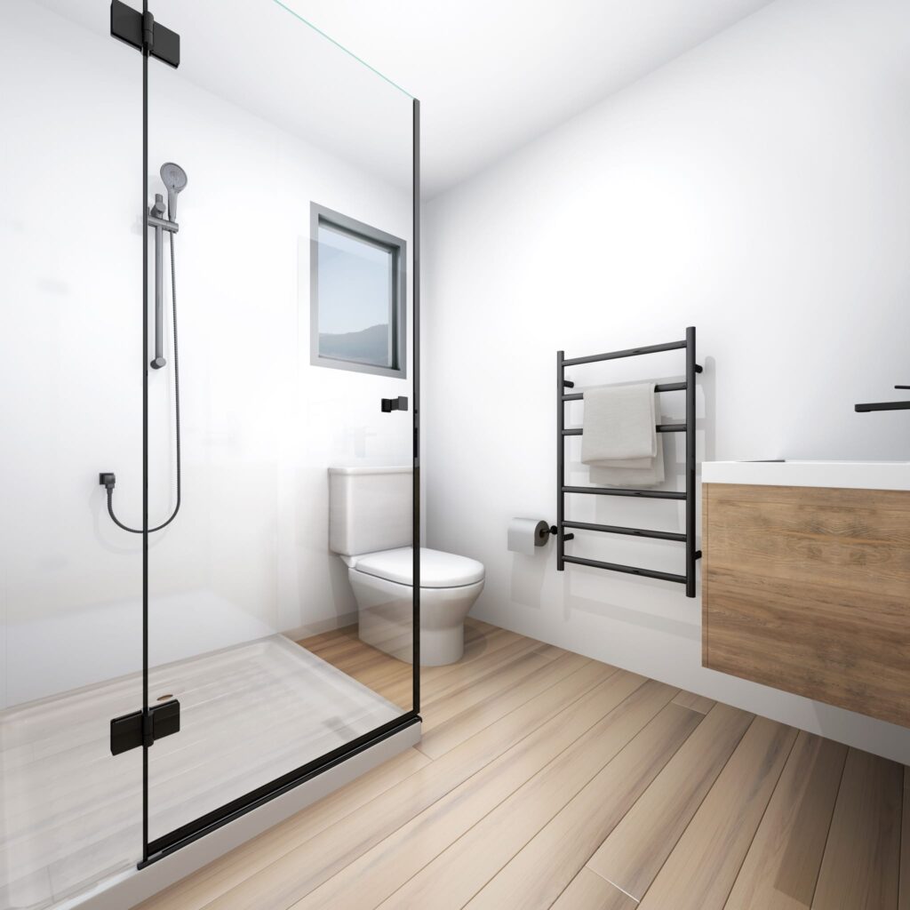Contemporary bathroom in a two-bedroom relocatable home NZ with glass shower, timber vanity and sleek black fixtures — compact, practical and stylish.