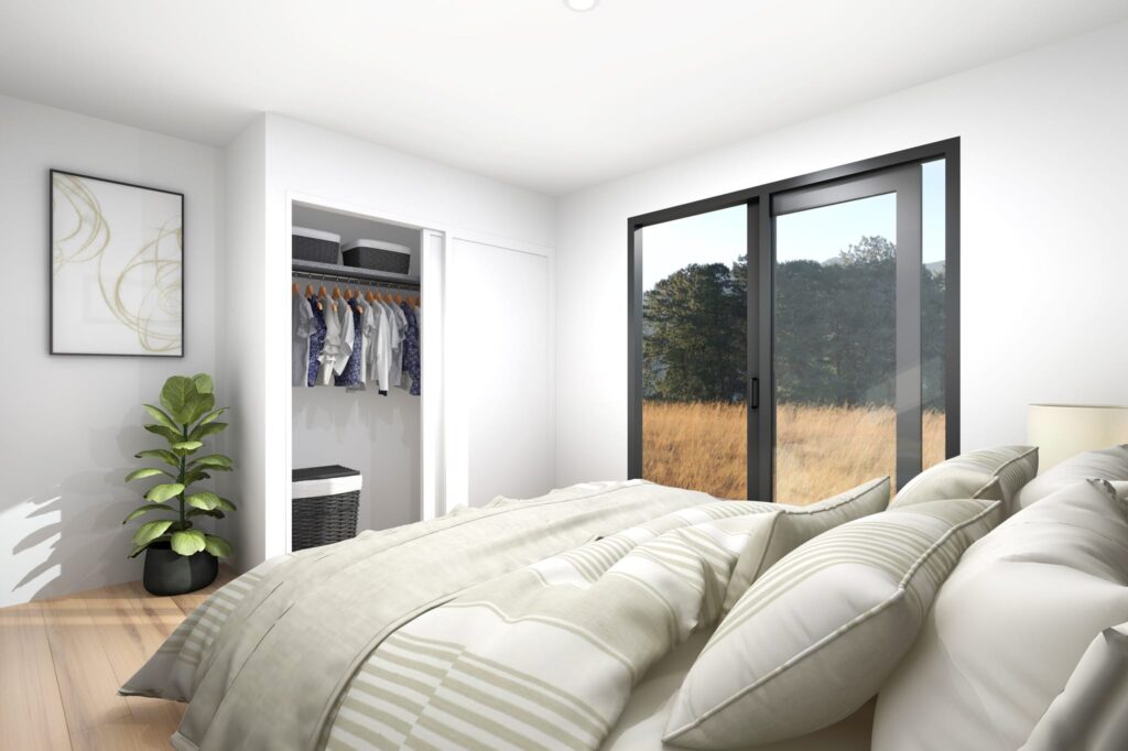 Sunny bedroom in a three-bedroom portable home NZ with built-in wardrobe, sliding doors and natural timber flooring — elegant design by Paragon Portables.