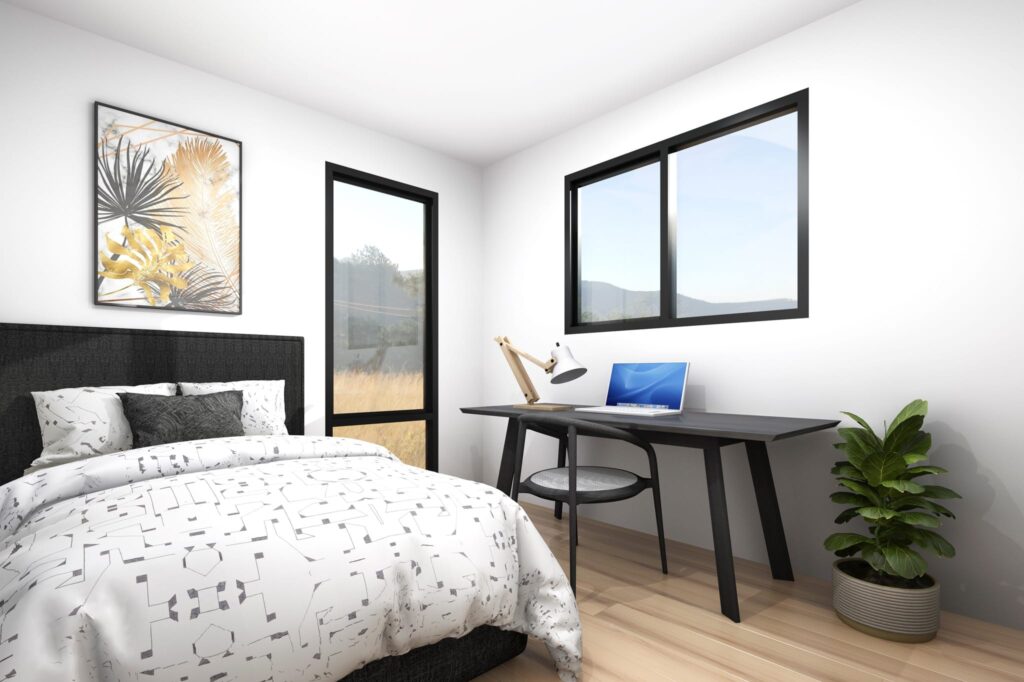 Bedroom and workspace combination inside a three-bedroom relocatable home NZ, featuring modern décor and views of the countryside.