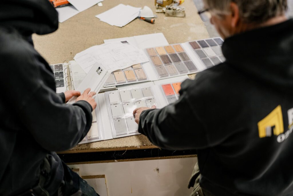 Team reviewing colour and material samples for new builds NZ at Paragon Portables, custom portable homes NZ.